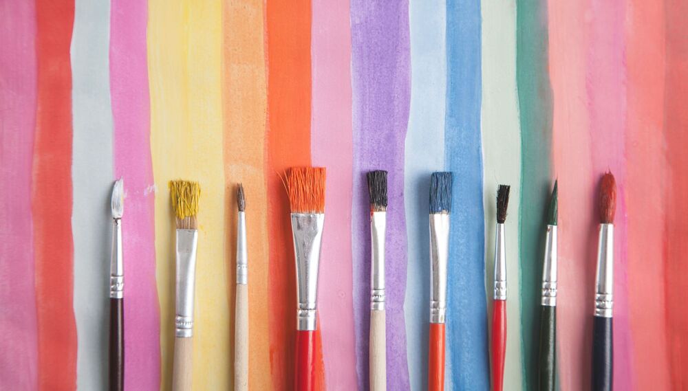 Paintbrush on watercolor painted background. Art. Hobby